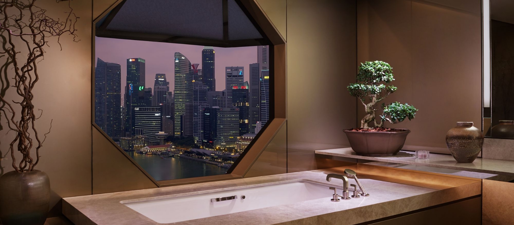 Soaking tub and octagonal window overlooking Singapore